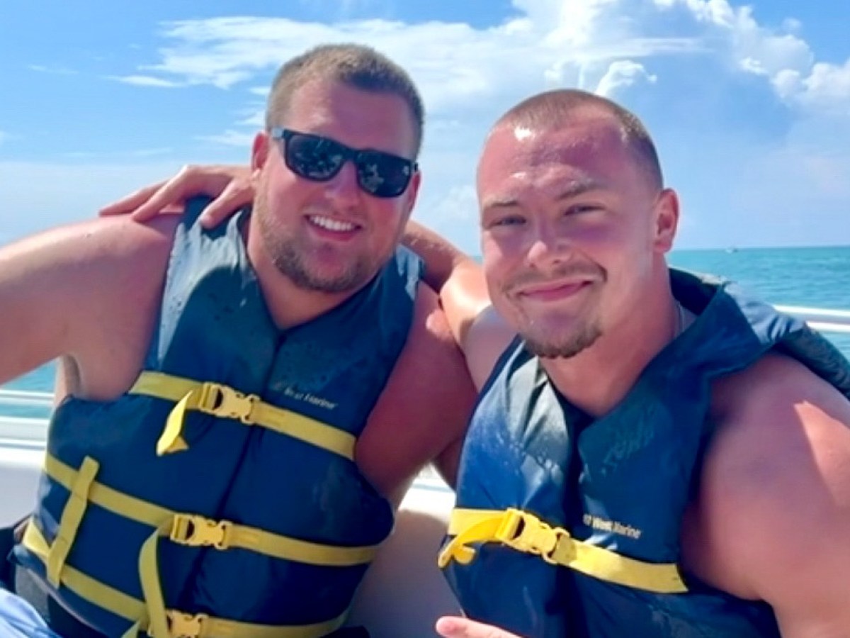 a couple of people that are standing in a body of water